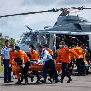 مسعفون إندونيسيون ينقلون جثة أحد ضحايا الطائرة المنكوبة - 2 يناير 2015.