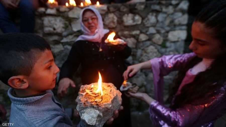 أسرة إيزيدية تحضر المصابيح للاحتفال برأس السنة الإيزيدية