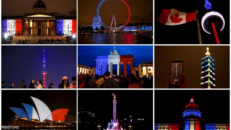 صورة تظهر الألوان الأزرق والأبيض والأحمر من العلم الوطني الفرنسي في محيط المباني والأبراج في جميع أنحاء العالم تكريما لضحايا الهجمات