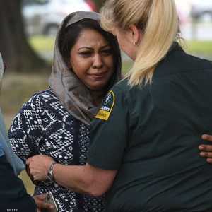 شرطة تواسي إحدى النساء من أهالي ضحايا مذبحة المسجدين.