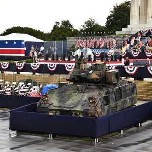 دبابة وحشود تراقب خلال العرض العسكري