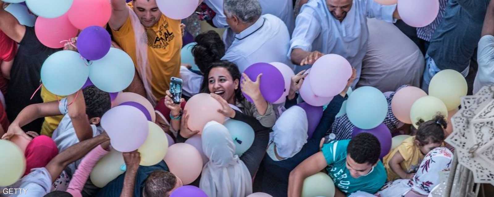 مصر.. يحاولون فرحين الإمساك ببالونات العيد