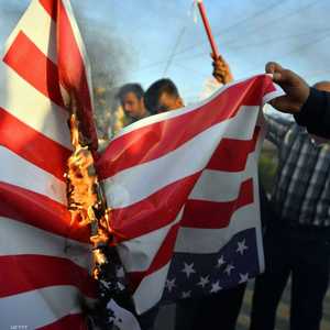 متظاهرون عراقيون غاضبون يحرقون العلم الأميركي.