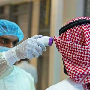 فحص حراري لمواطن كويتي قبل دخوله مجمع الوزارات في العاصمة