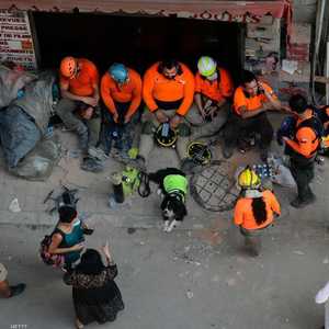 فريق البحث التشيلي مع الكلب المتخصص بأعمال البحث عن ناجين