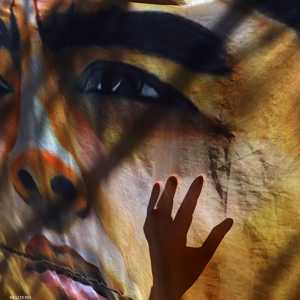 عشاق مارادونا يعلقون صورة له أمام المستشفى الذي يرقد فيه