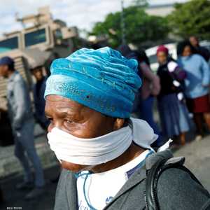 سيدة أفريقية تتخذ من اللثام كمامة للوقاية من الفيروس