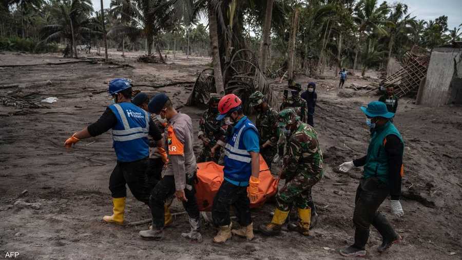 رجال الإنقاذ يبحثون في الرماد والطين للعثور على ناجين وجثث.
