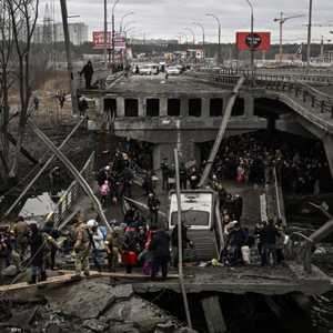 مدنيون يحاولون عبور جسر مدمر في أوكرانيا