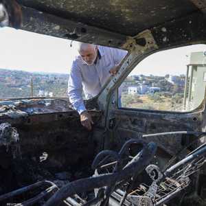 فلسطيني يتفقد سيارته التي حرقت في هجوم للمستوطنين على سلفيت