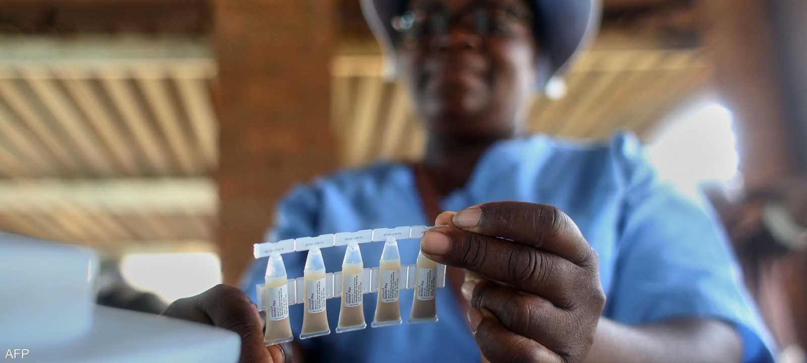 عامل صحي يحمل عينة من لقاحات الكوليرا