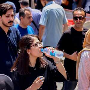 فتاة إيرانية تشرب الماء أثناء موجة حر في العاصمة طهران